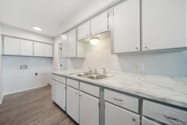 kitchen featuring white cabinetry, a sink, light countertops, and dark wood finished floors
