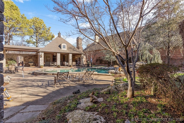 view of community with a swimming pool and a patio