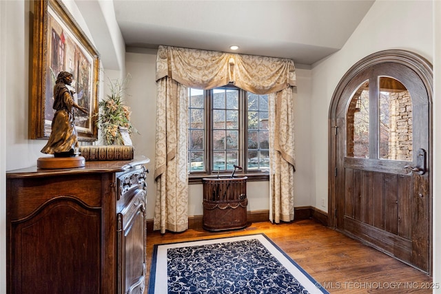 interior space with wood finished floors and baseboards