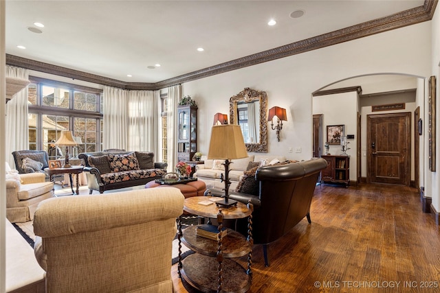 living area featuring arched walkways, dark wood finished floors, ornamental molding, and recessed lighting