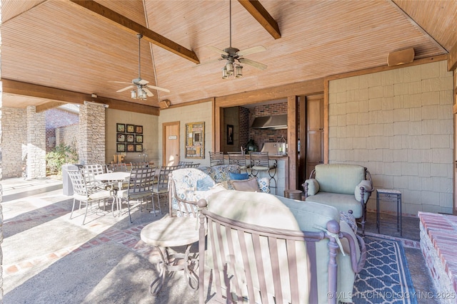 view of patio / terrace featuring ceiling fan, outdoor dining space, and exterior kitchen