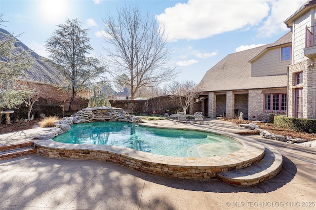 view of swimming pool featuring a fenced backyard, a fenced in pool, and a patio