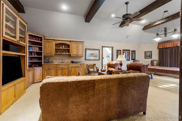 living area with light colored carpet, a ceiling fan, vaulted ceiling with beams, and indoor bar