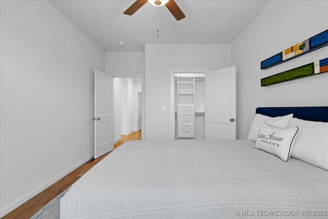 12202 S 102 E Ave, Bixby, OK 74008 - bedroom with a spacious closet, baseboards, ceiling fan, and wood finished floors