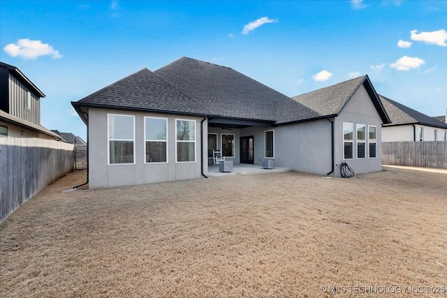 12202 S 102 E Ave, Bixby, OK 74008 - back of property with stucco siding, a fenced backyard, roof with shingles, and a patio area