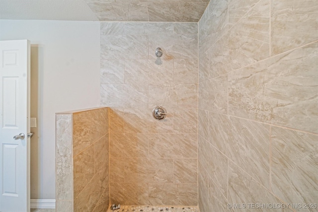 full bath with tiled shower