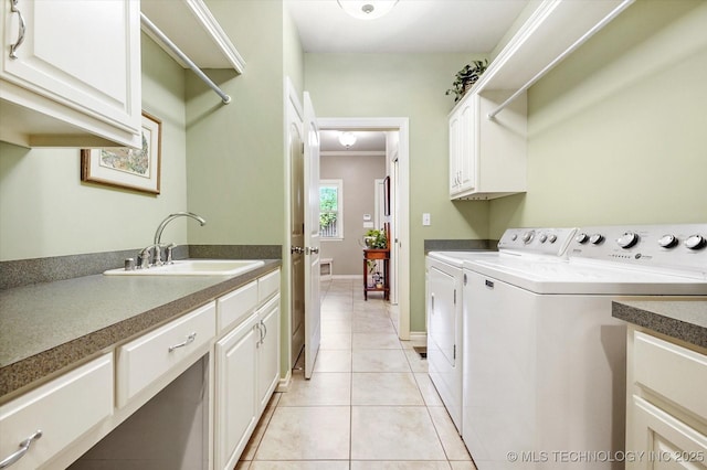11748 S Canton Ave, Tulsa, OK 74137 - laundry area featuring light tile patterned floors, baseboards, separate washer and dryer, a sink, and cabinet space