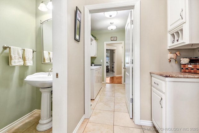 11748 S Canton Ave, Tulsa, OK 74137 - bathroom featuring washer and clothes dryer, baseboards, and tile patterned floors
