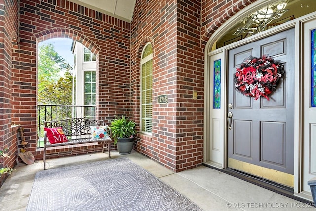 11748 S Canton Ave, Tulsa, OK 74137 - doorway to property featuring brick siding and a porch