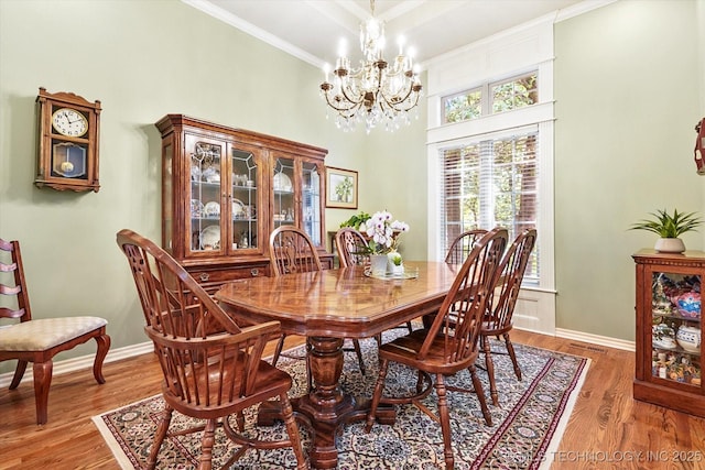 11748 S Canton Ave, Tulsa, OK 74137 - dining space featuring baseboards, a notable chandelier, light wood-style flooring, and crown molding