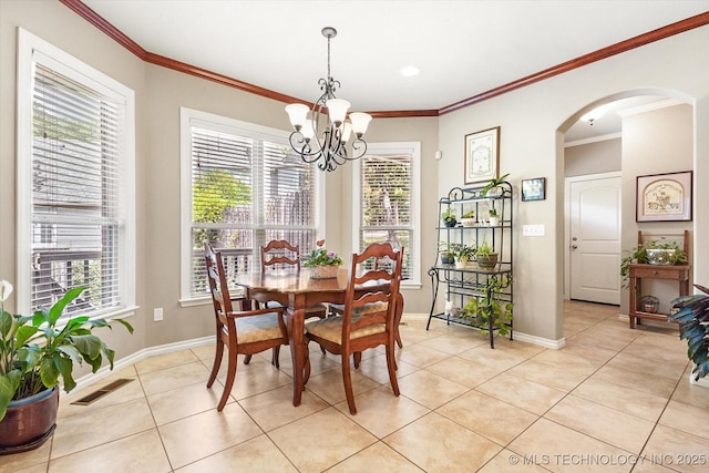 11748 S Canton Ave, Tulsa, OK 74137 - dining area with plenty of natural light, a chandelier, light tile patterned flooring, arched walkways, and visible vents