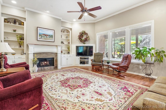 11748 S Canton Ave, Tulsa, OK 74137 - living area featuring crown molding, a ceiling fan, wood finished floors, a premium fireplace, and built in features