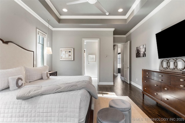 bedroom with crown molding, a tray ceiling, recessed lighting, dark wood-style flooring, and baseboards