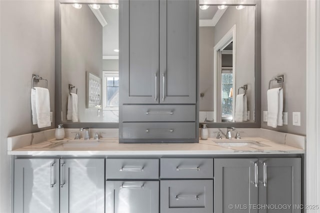 bathroom featuring a sink, a wealth of natural light, and crown molding