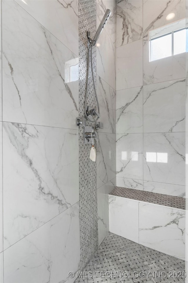 details featuring a marble finish shower