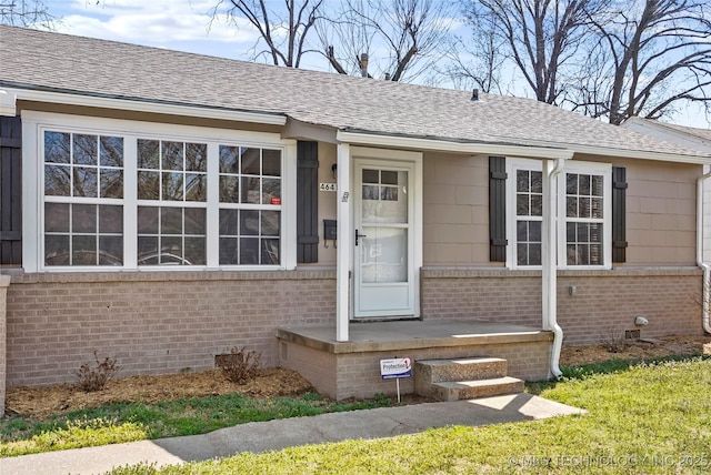 4641 S Trenton Ave, Tulsa, OK 74105 - view of exterior entry featuring crawl space, brick siding, and roof with shingles