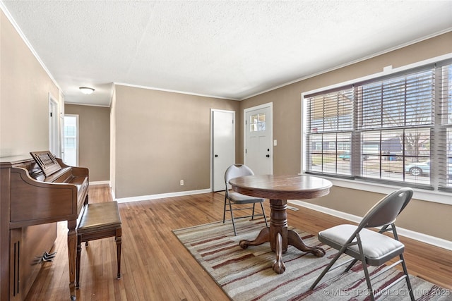 4641 S Trenton Ave, Tulsa, OK 74105 - dining area with baseboards, crown molding, wood finished floors, and a textured ceiling
