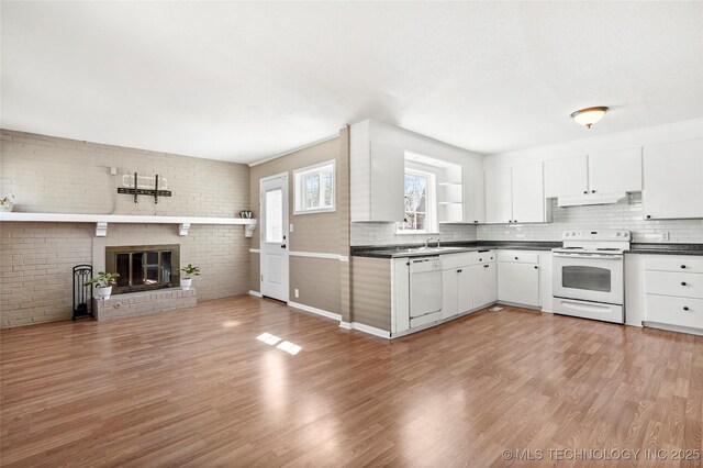 4641 S Trenton Ave, Tulsa, OK 74105 - kitchen with light wood-style flooring, white appliances, dark countertops, tasteful backsplash, and under cabinet range hood