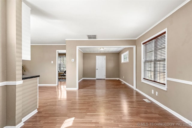 4641 S Trenton Ave, Tulsa, OK 74105 - interior space featuring baseboards, visible vents, crown molding, and wood finished floors