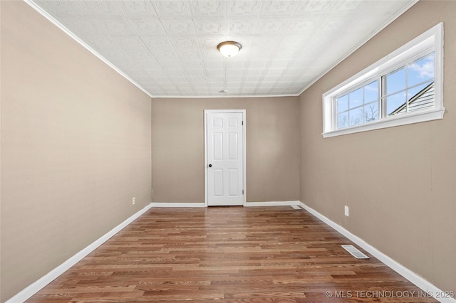 4641 S Trenton Ave, Tulsa, OK 74105 - unfurnished room with baseboards, visible vents, wood finished floors, and ornamental molding