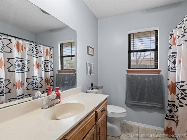 bathroom with a shower with shower curtain, toilet, vanity, a textured ceiling, and tile patterned flooring