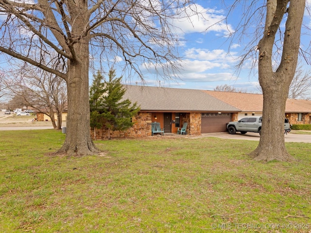 ranch-style home with stone siding, an attached garage, a front yard, driveway, and a shingled roof
