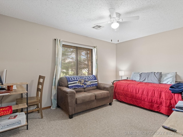 carpeted bedroom featuring a textured ceiling, visible vents, and ceiling fan