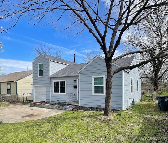 rear view of property featuring concrete driveway, roof with shingles, fence, an attached garage, and a yard