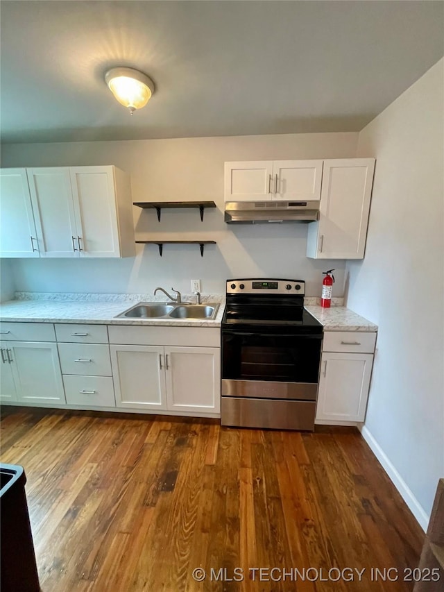 kitchen featuring light countertops, a sink, open shelves, under cabinet range hood, and stainless steel electric stove