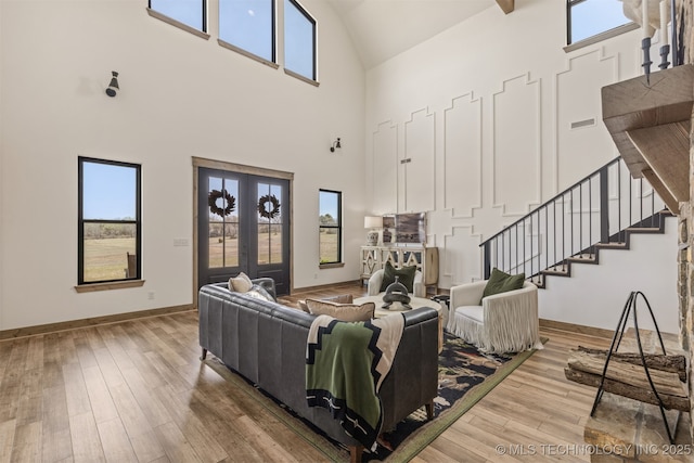 22450 S Rocky Ridge Ln, Claremore, OK 74019 - living area with high vaulted ceiling, stairs, wood-type flooring, and plenty of natural light