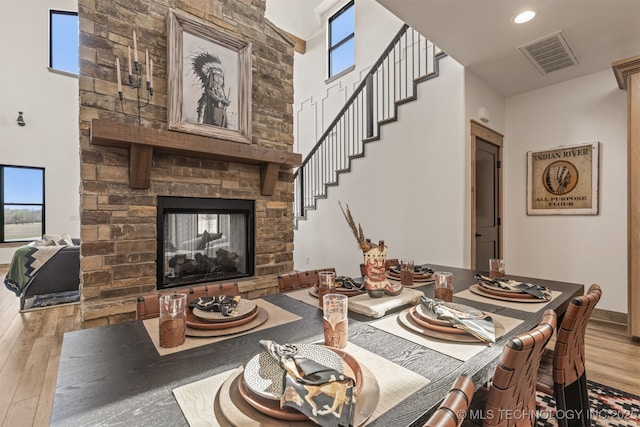 22450 S Rocky Ridge Ln, Claremore, OK 74019 - living room with wood finished floors, a fireplace, a towering ceiling, and recessed lighting