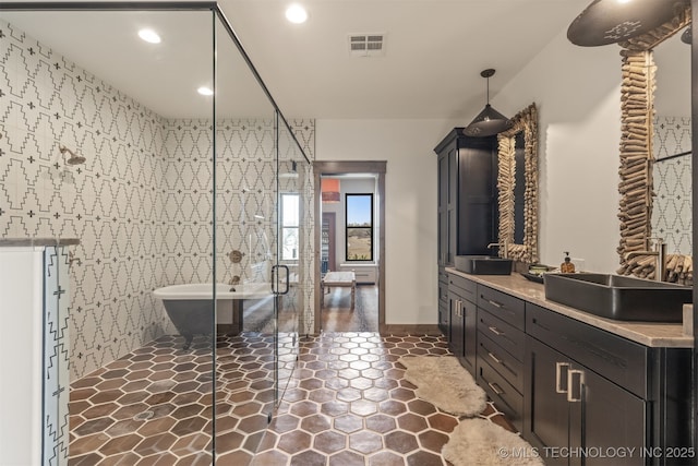22450 S Rocky Ridge Ln, Claremore, OK 74019 - bathroom with a freestanding tub, double vanity, a stall shower, recessed lighting, and tile patterned floors