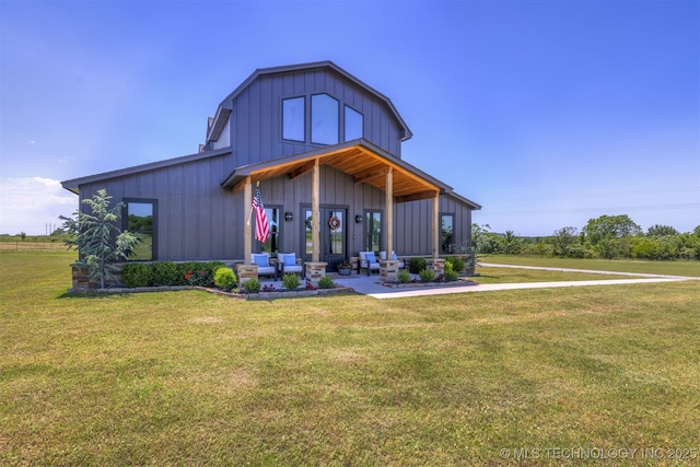 22450 S Rocky Ridge Ln, Claremore, OK 74019 - view of front of property with board and batten siding and a front yard