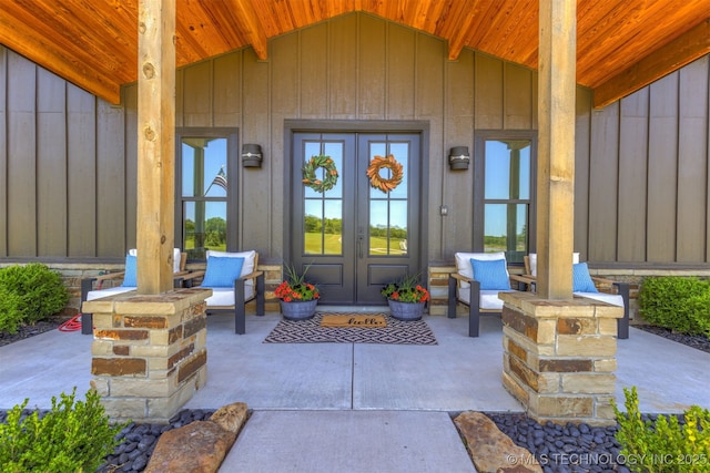 22450 S Rocky Ridge Ln, Claremore, OK 74019 - view of exterior entry featuring french doors and board and batten siding