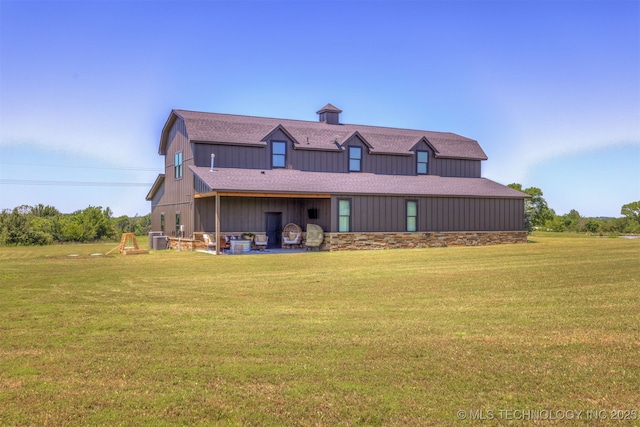 22450 S Rocky Ridge Ln, Claremore, OK 74019 - back of property with central AC, a yard, a patio area, and roof with shingles