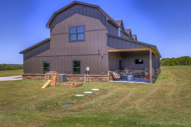 22450 S Rocky Ridge Ln, Claremore, OK 74019 - back of house featuring a yard, a patio, board and batten siding, and a barn