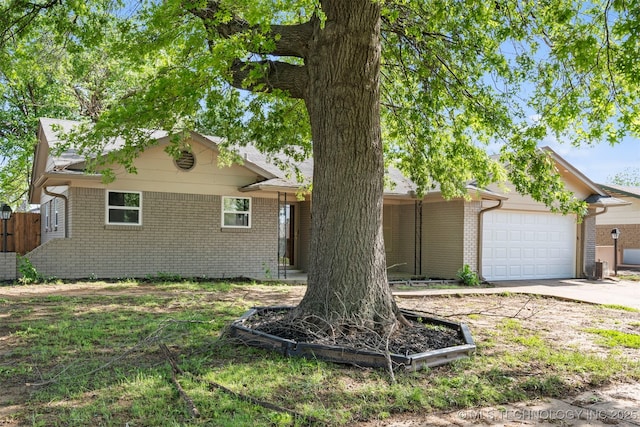 212 W 17th St, Owasso, OK 74055 - ranch-style house featuring a garage, driveway, and brick siding