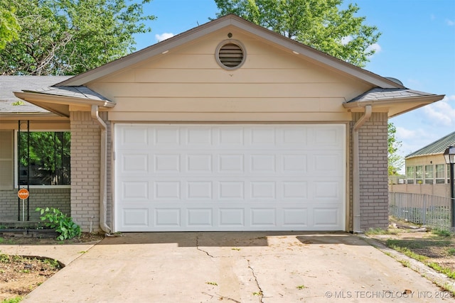 212 W 17th St, Owasso, OK 74055 - garage featuring fence and driveway