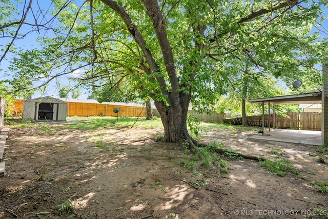212 W 17th St, Owasso, OK 74055 - view of yard featuring a patio, an outbuilding, a fenced backyard, and a storage unit