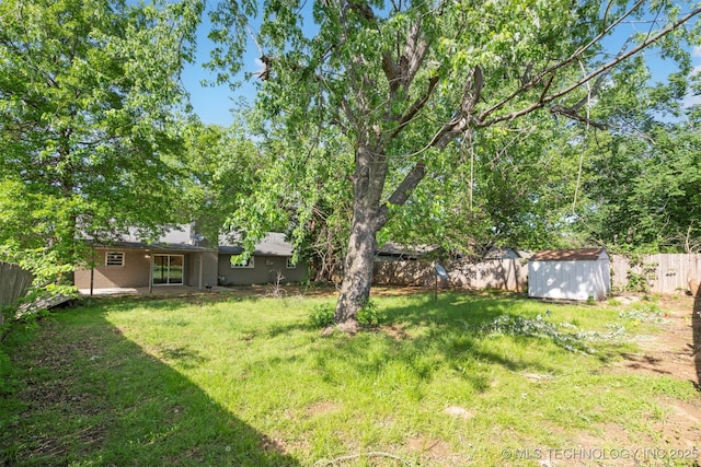 212 W 17th St, Owasso, OK 74055 - view of yard with a fenced backyard, an outdoor structure, and a shed