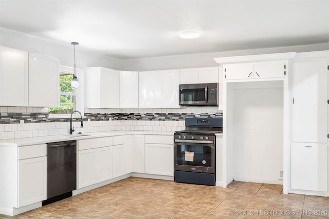 212 W 17th St, Owasso, OK 74055 - kitchen with light countertops, a sink, tasteful backsplash, and stainless steel appliances