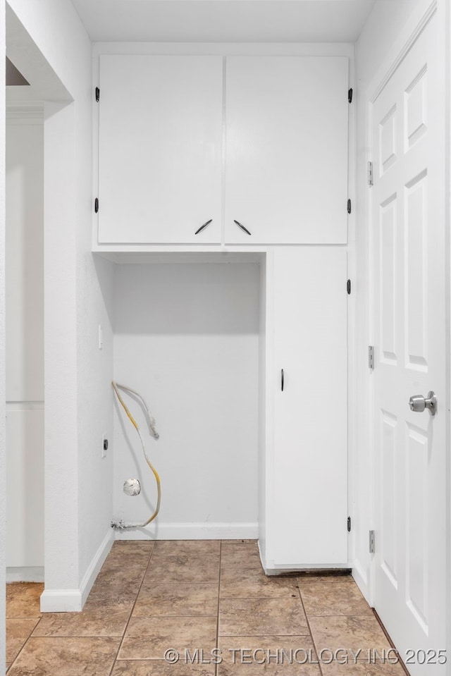212 W 17th St, Owasso, OK 74055 - laundry area with cabinet space, baseboards, and light tile patterned floors