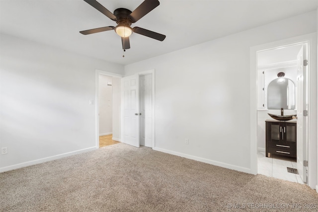 212 W 17th St, Owasso, OK 74055 - unfurnished bedroom featuring baseboards, a ceiling fan, and light colored carpet