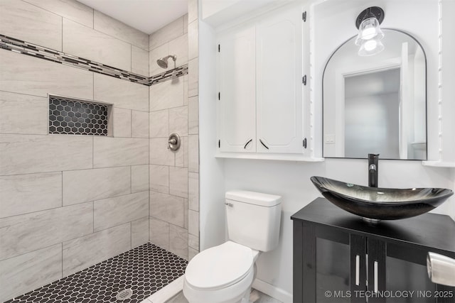 212 W 17th St, Owasso, OK 74055 - bathroom featuring vanity, baseboards, toilet, and tiled shower