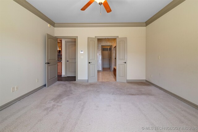 9707 E 90th Ct N, Owasso, OK 74055 - unfurnished bedroom featuring carpet floors, a walk in closet, crown molding, and baseboards