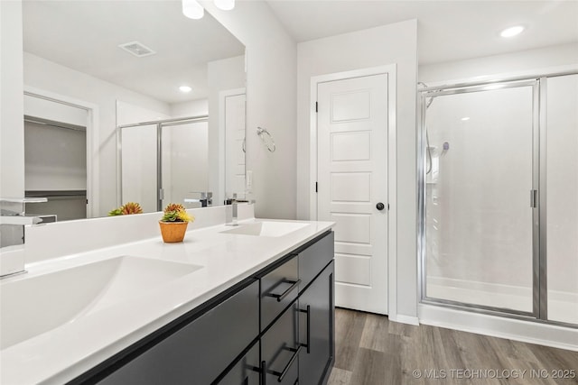 13119 S 72nd E Pl, Bixby, OK 74008 - full bathroom with a sink, double vanity, a shower stall, and wood finished floors