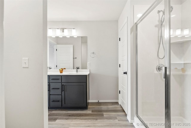 13119 S 72nd E Pl, Bixby, OK 74008 - bathroom featuring vanity, baseboards, a stall shower, and wood finished floors