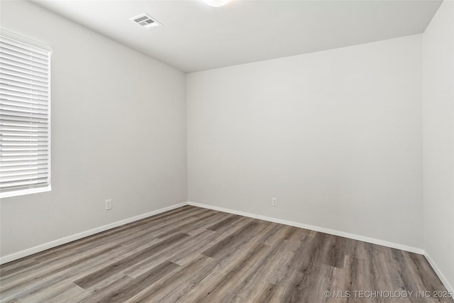 13119 S 72nd E Pl, Bixby, OK 74008 - spare room with baseboards, wood finished floors, and visible vents