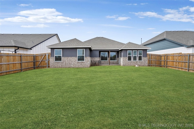13119 S 72nd E Pl, Bixby, OK 74008 - back of property with a fenced backyard, a yard, roof with shingles, and brick siding