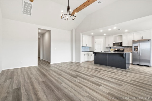 13119 S 72nd E Pl, Bixby, OK 74008 - kitchen featuring appliances with stainless steel finishes, a sink, tasteful backsplash, beamed ceiling, and visible vents